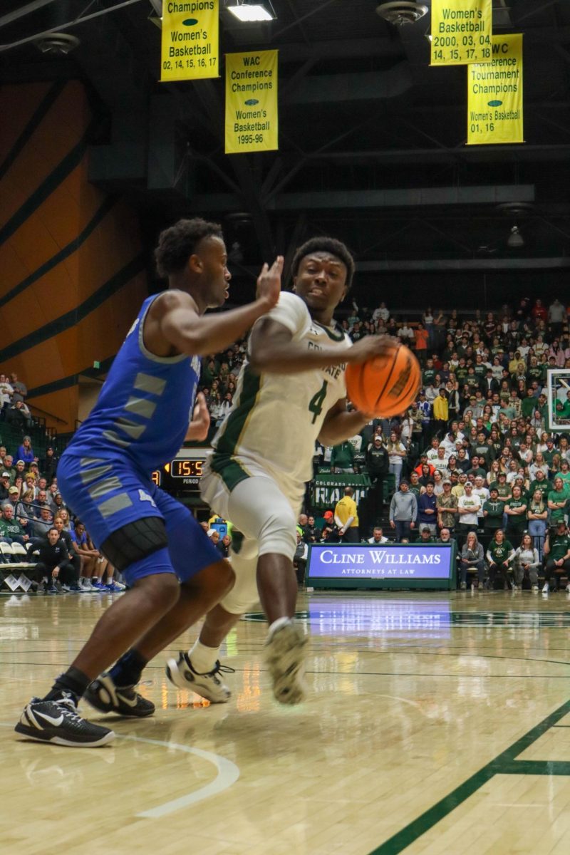 No. 4, Isaiah Stevens pushes past Air Force defense in the basketball game against the Air Force Academy, CSU won in overtime, 78-69.