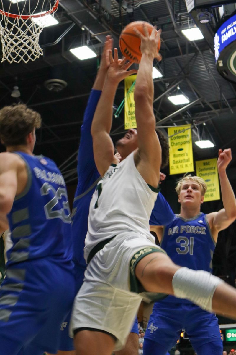 No. 1, Joel Scott fights to score in the basketball game against the Air Force Academy, CSU won in overtime, 78-69.