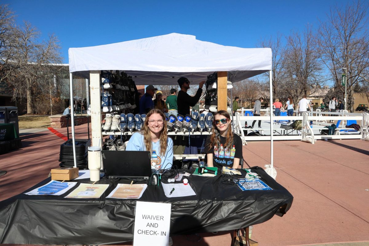 Colorado State University students Sophia Mechling and Fayth Hiatt run the check in table at "Rams on Ice".  "We're trying to engage students more on campus and it's just a relaxing thing for them to do, especially with new classes and exams starting," Mechling said. Jan. 31.