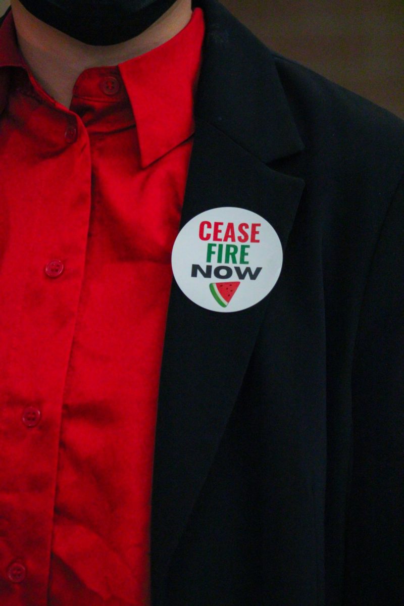 A local high schooler wears a Cease Fire Now sticker at a Fort Collins city council meeting.
