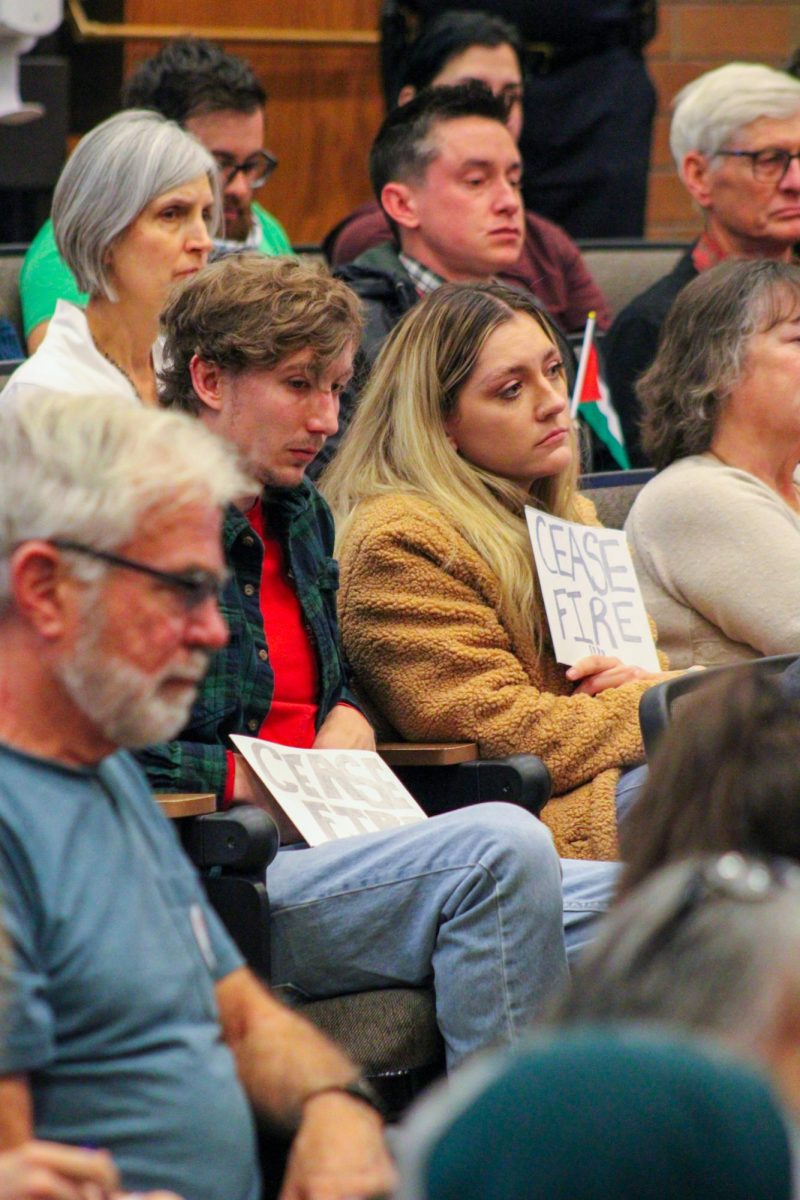 River Heide holds a cease fire sign while community members call on the Fort Collins City Council to approve a ceasefire in Gaza.