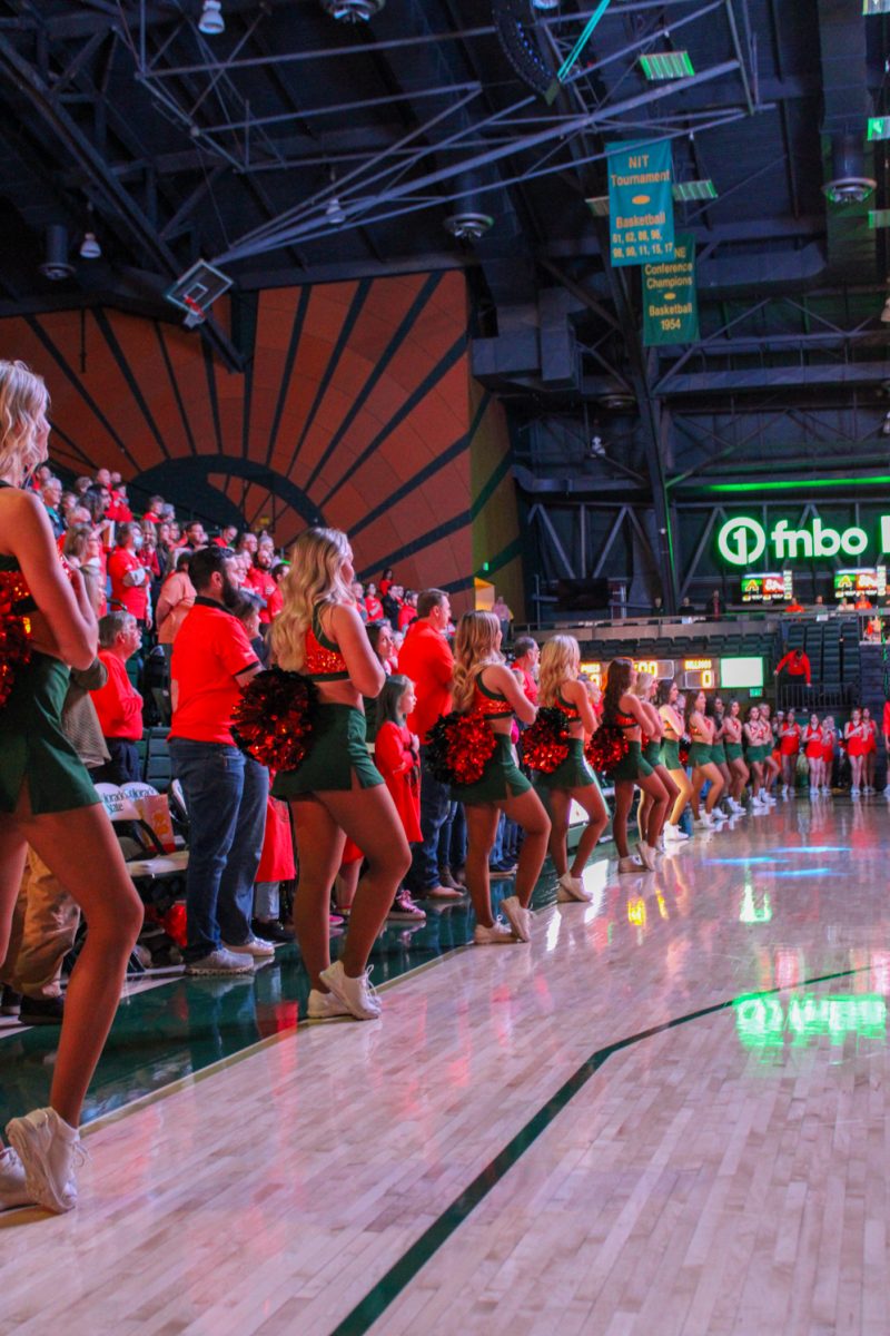 The Colorado State Golden Poms Team stand for the National Anthem before the CSU womens basketball team takes on Fresno State.