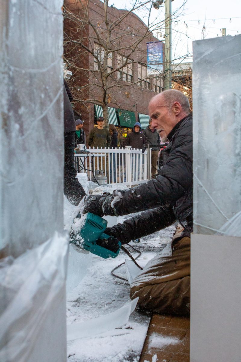 Ice carver Thomas Barlow uses a chainsaw to cut through thick ice and smooth the edges of his igloo in Old Town Fort Collins on Feb. 2, 2024. 