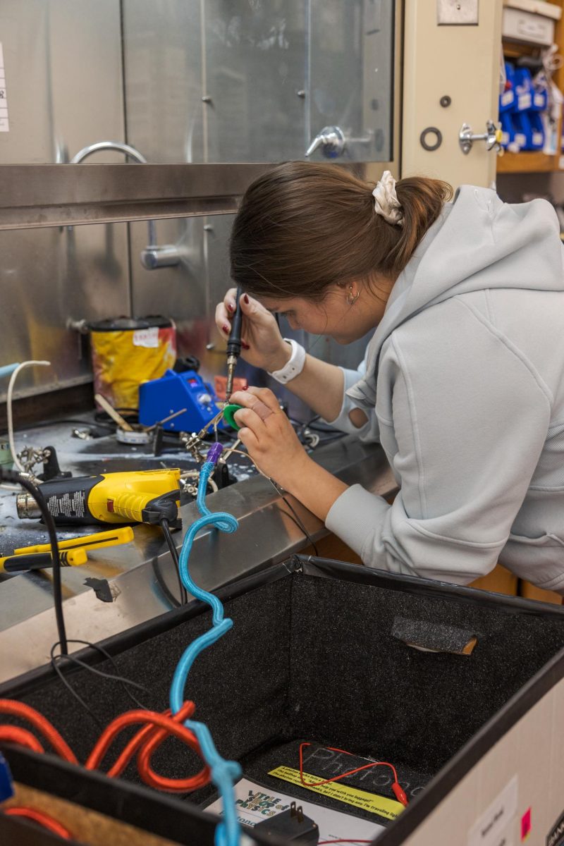 Little Shop of Physics student intern Grace Balle solders a project in preparation for the upcoming Open House Feb. 15. Ball learned to solder during her internship.
