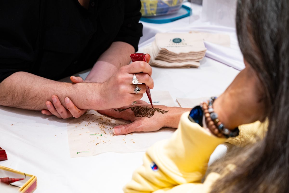 College of Liberal Arts Budget Manager Lillian Nugent gets henna done at the World Unity Fair Feb. 17. "I have a very deep passion for multicultural experiences," Nugent said. "And I love our international students and appreciate that they're here and want to support them."
