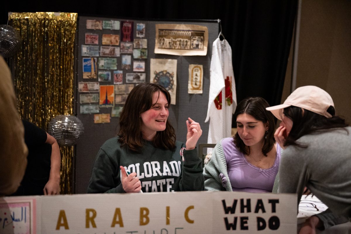 Arabic Culture and Language Club President Thalia Gustina speaks to a person visiting their booth at the World Unity Fair Feb. 17. "It was super fun to be here and see all the different cultures," Gustina said. "I really liked watching the cultural performances, those were really cool."