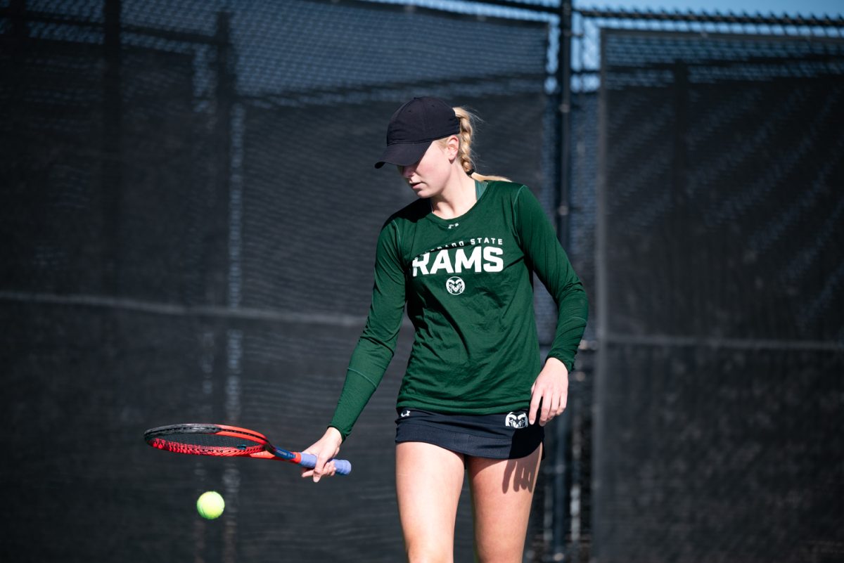 Junior Sarah Weekley gets ready to serve at a singles match against Northern Arizona University.