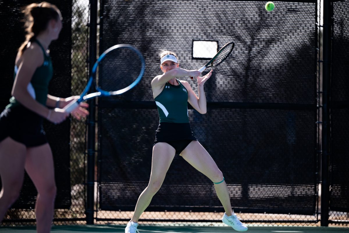 Senior Viktoryia Zhadzinskaya hits the ball during a doubles match with graduate student Radka Buzkova against Northern Arizona University.