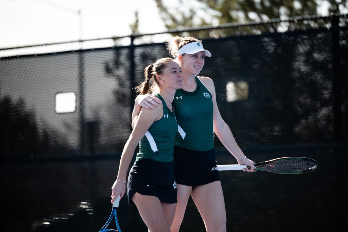 Radka Buzkova and Viktoryia Zhadzinskaya celebrate after winning their doubles match against Northern Arizona University.