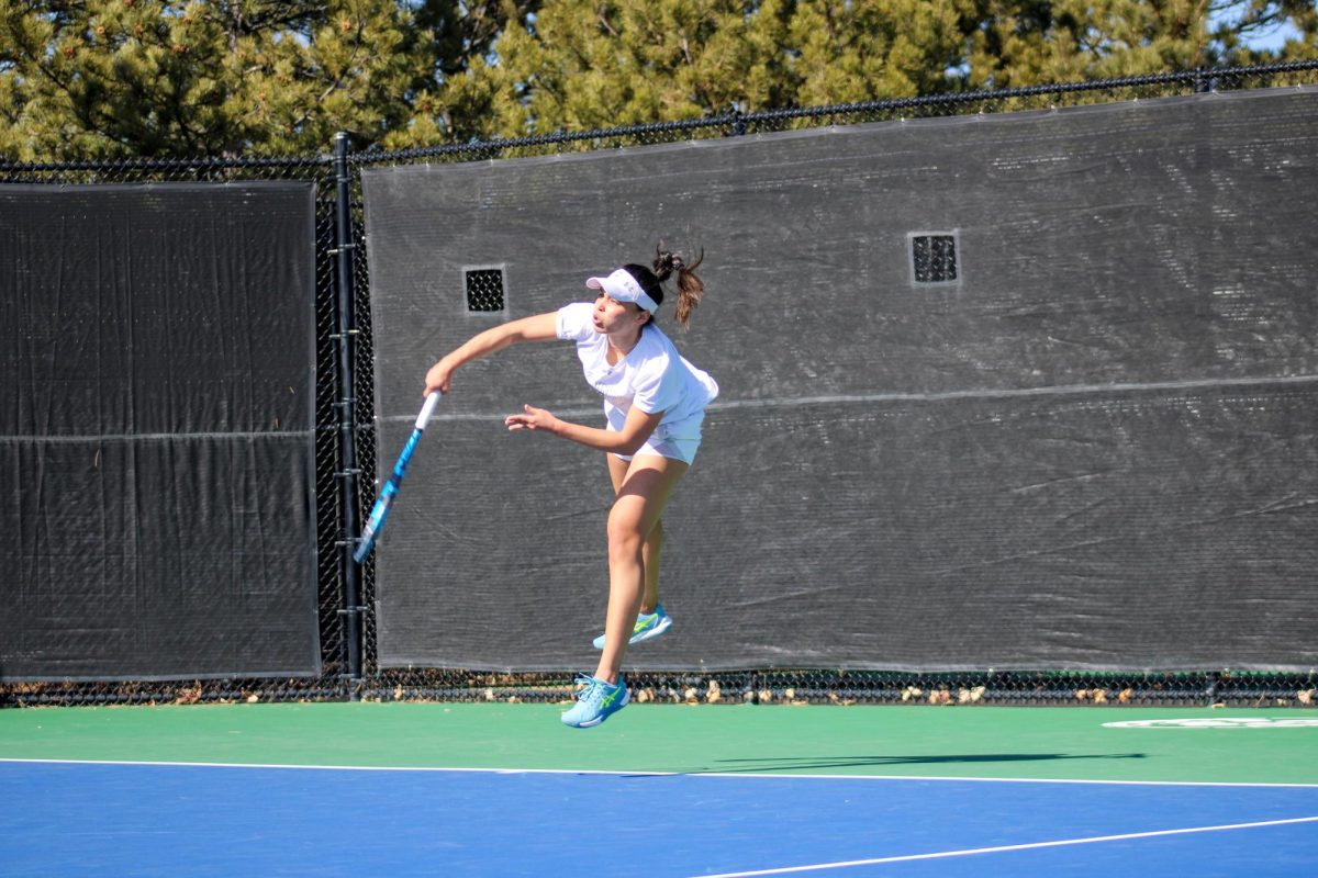 Zara Lennon jumps as serves the ball to her University of Colorado opponent Feb. 25.