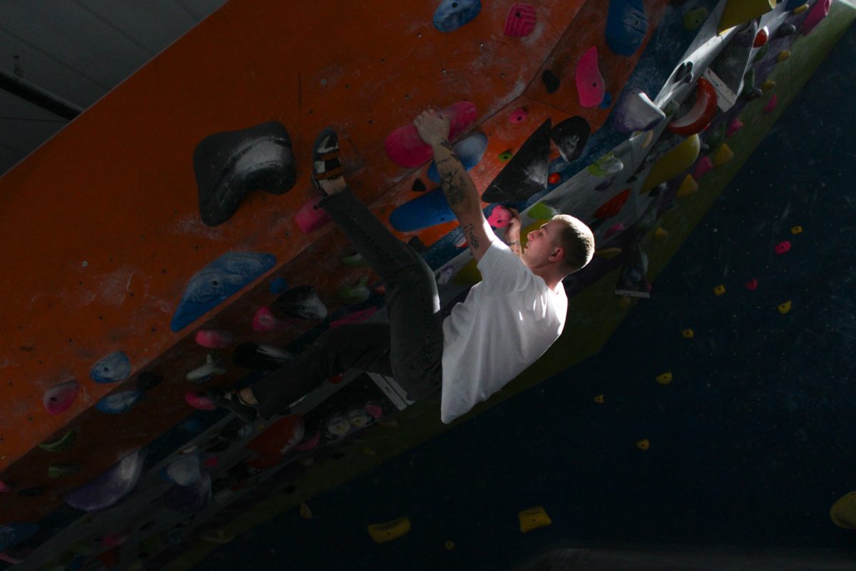 Looking for his next footing, Mitch Perez does an overhand climb at Ascent Studio Climbing and Fitness Feb. 26.