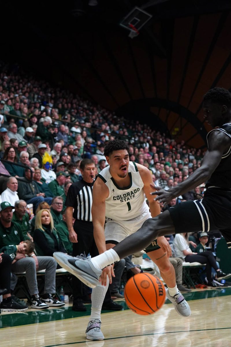 Colorado State University player Joel Scott passes the ball to another player in the men’s basketball game vs. Utah State Feb 17.