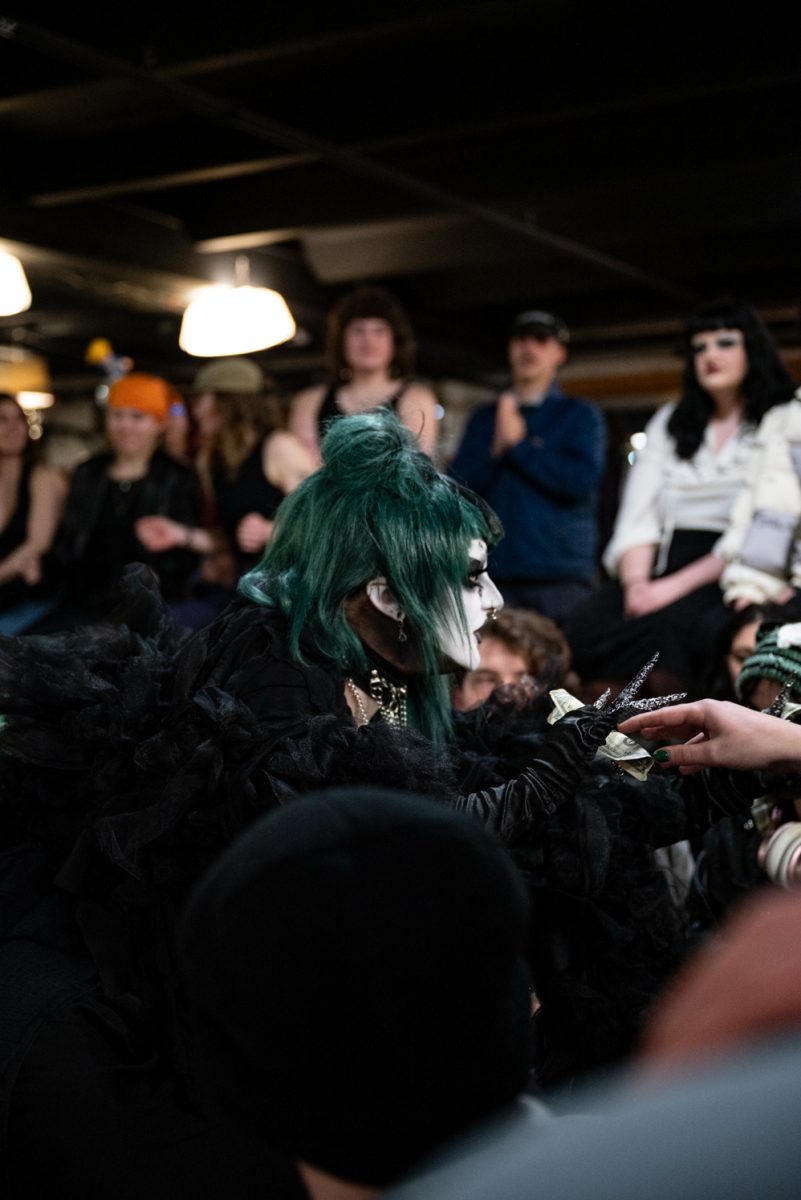 Miss Construed takes a dollar from an audience member during her performance at the Funktastic Drag Show.