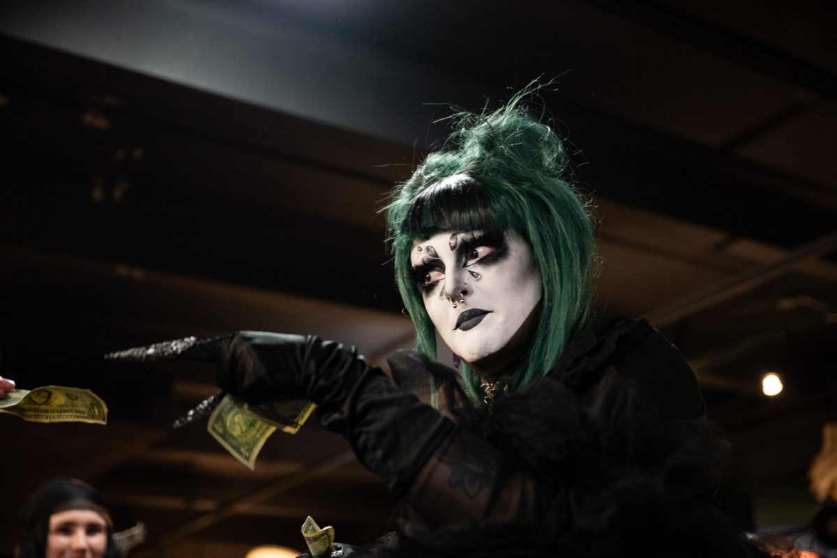 Miss Construed takes a dollar from an audience member during her performance at the Funktastic Drag Show.