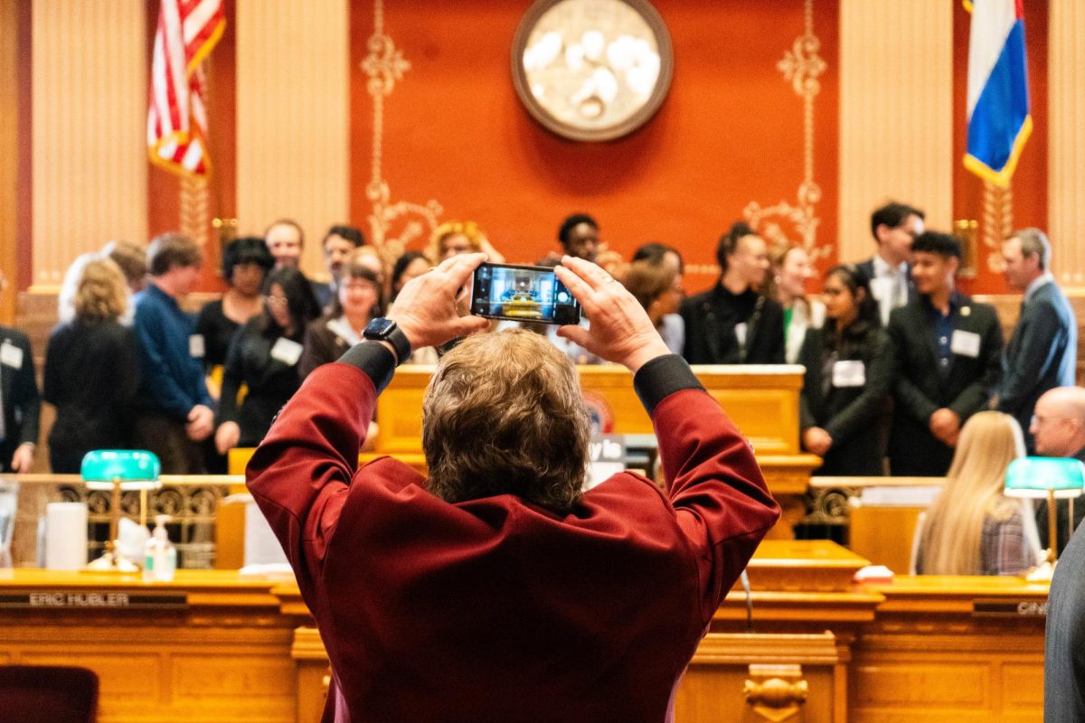 A security guard takes a group photo of members of the Associated Students of Colorado State University at the front of the Colorado State Capitol Senate chambers Feb. 8. The Senate chambers, which are within the State Capitol Building, are home to all senate proceedings of the Colorado General Assembly.