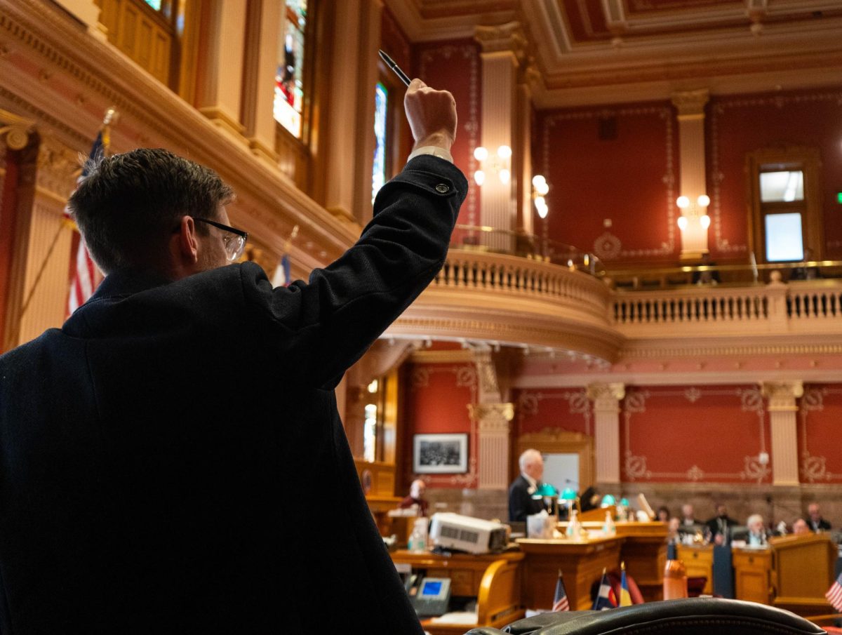 A senator raises his pen to indicate attendance at the Senate session of the Colorado General Assembly Feb. 8.