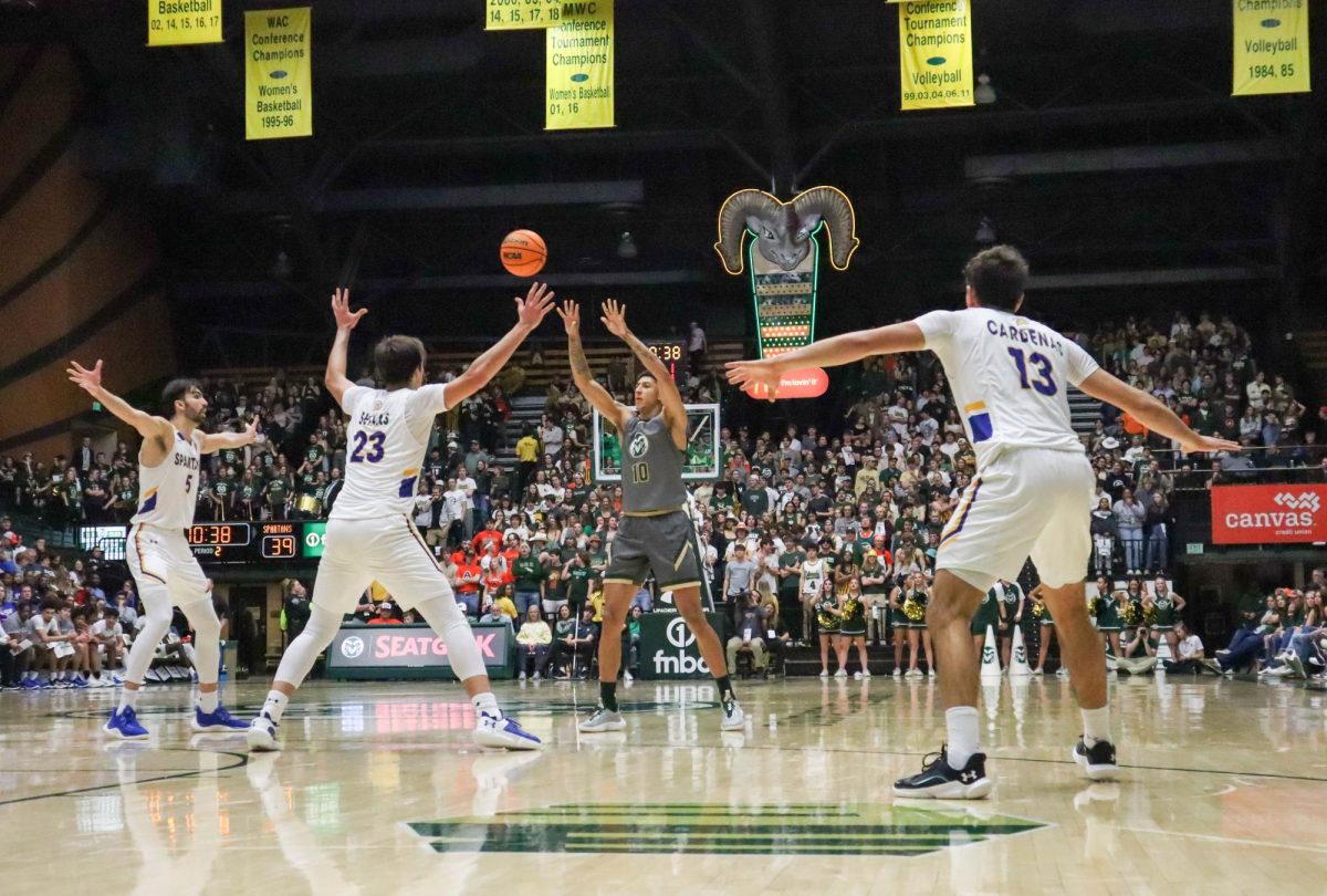 Colorado State University No. 10 Nique Clifford, cornered by San Jose State University players passes the ball overhead to a teammate at the basketball game against San Jose State University. CSU won 66-47. Feb. 9.