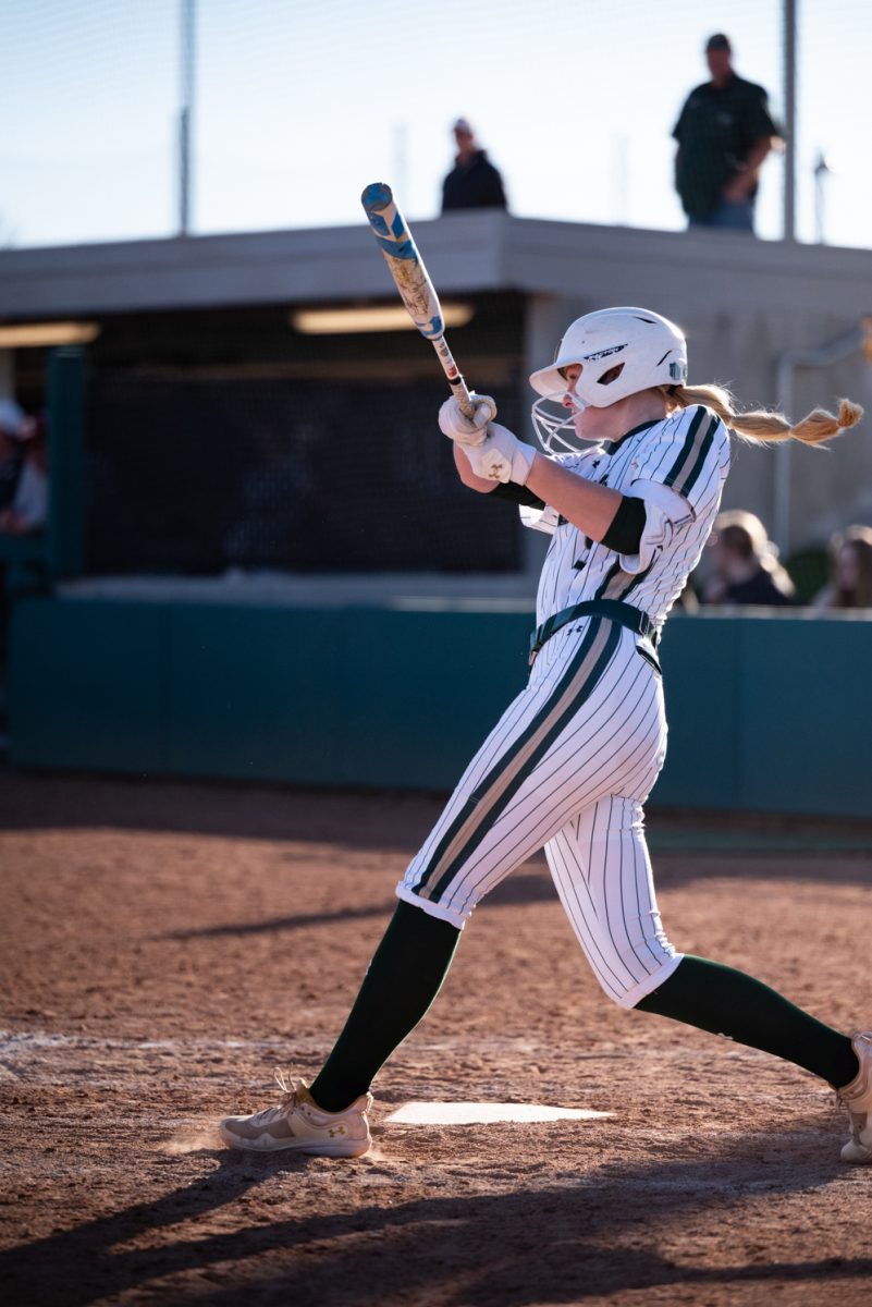 Junior Brooke Bohlender (8) hits a pitch from Iowa State.