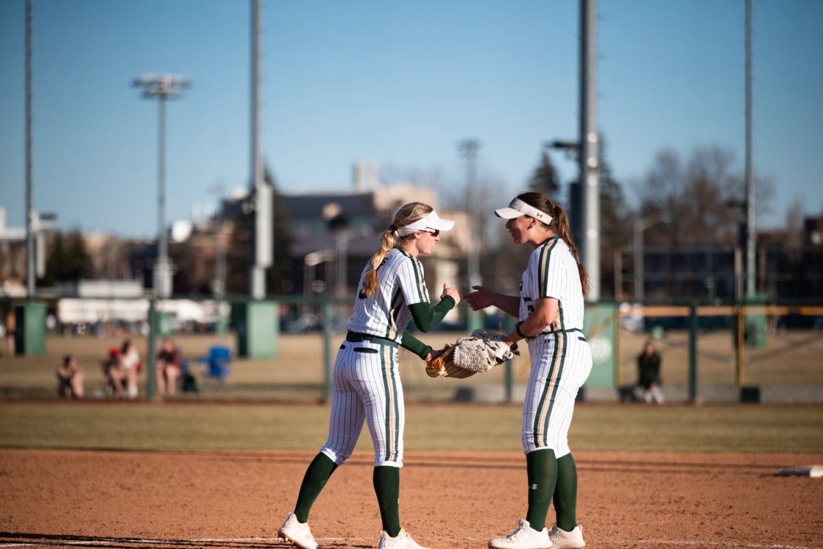 Morgan Crosby (3) and Sydney Hornbuckle (5) celebrate during the final inning against Iowa State.