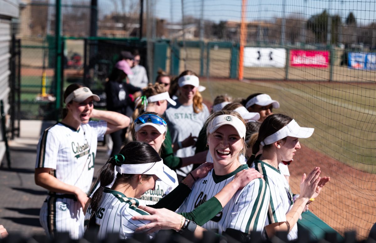 Colorado State University softball players celebrate a double home run against Iowa State.