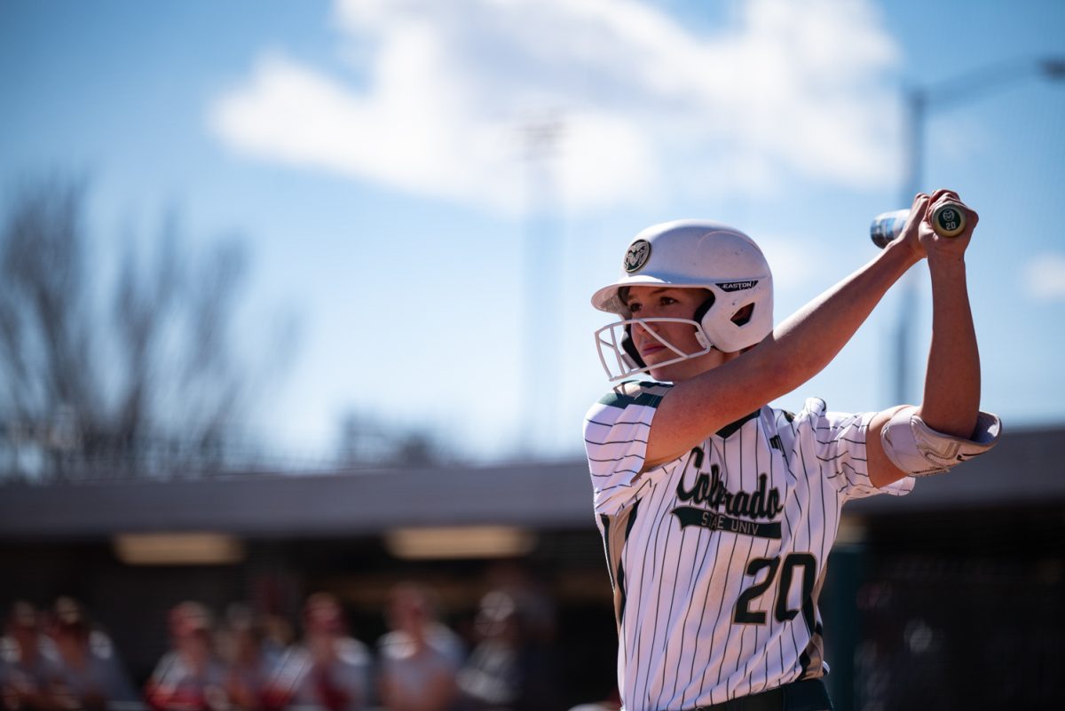 Junior Jordan West (20) takes a few practice swings before stepping up to bat against Iowa State.