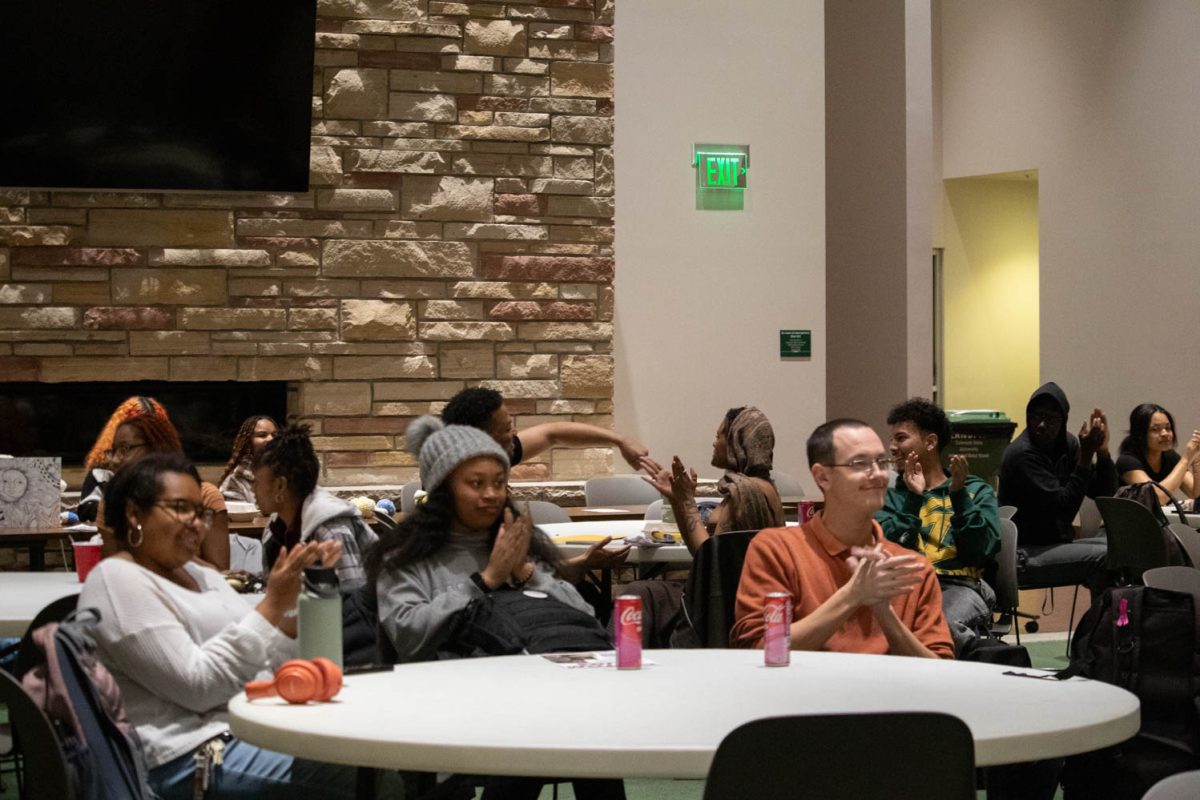The crowd claps following a performance during the Black History Month Closing Open Mic Night on February 29, 2024.