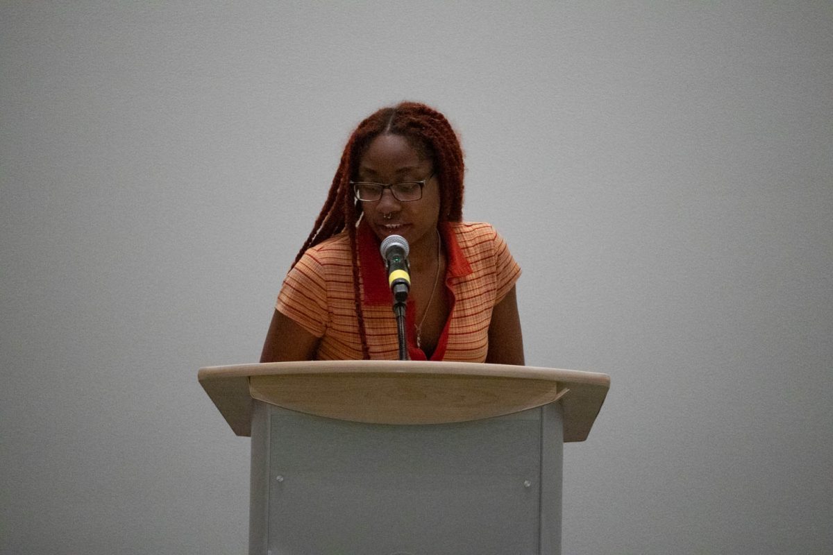 Kylynn White reads her poem, "Asha and Her Hope" during the Black History Month Closing Open Mic Night on February 29, 2024.
