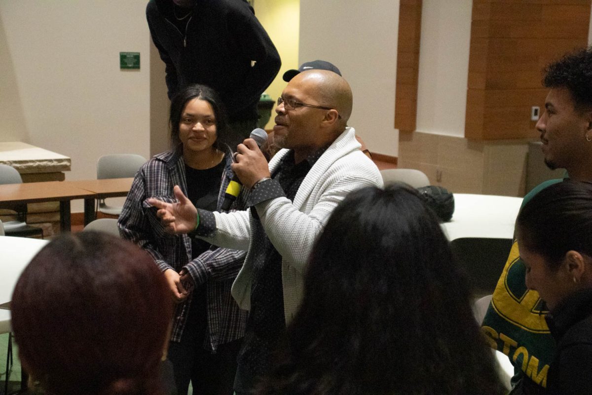 The crowd participates in the final performance during the Black History Month Closing Open Mic Night on February 29, 2024.