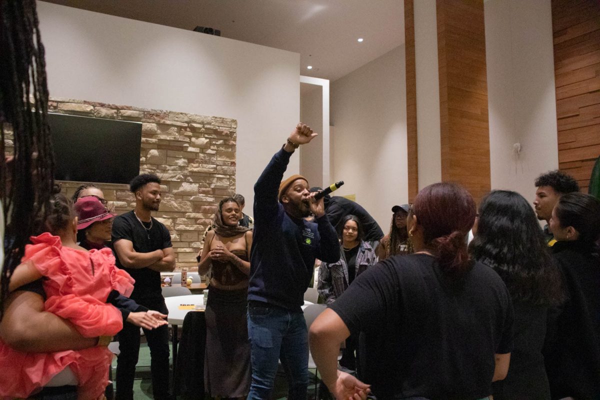 Wayne Watts performs with the crowd during the Black History Month Closing Open Mic Night on February 29, 2024.
