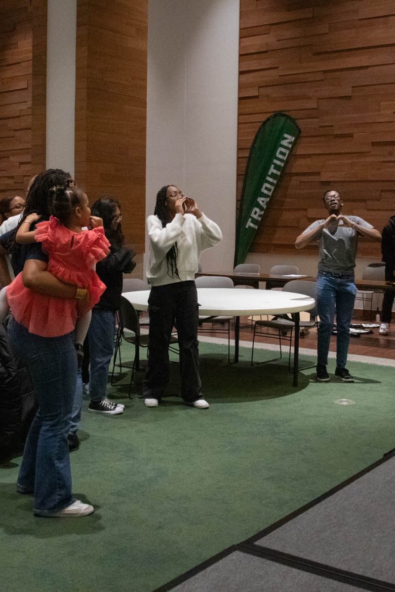 The crowd participates in the final performance during the Black History Month Closing Open Mic Night on February 29, 2024.