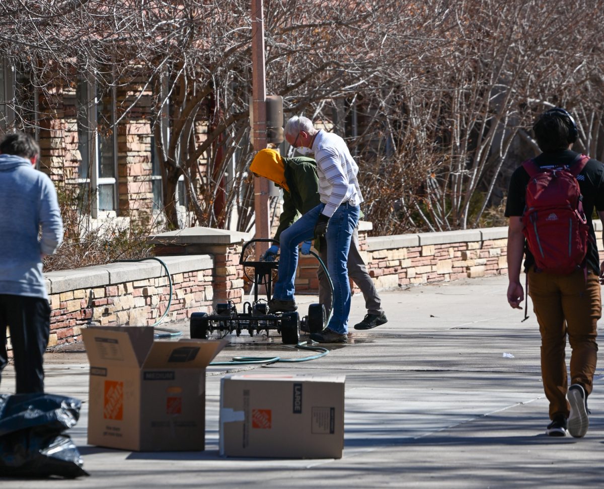 A student and his professor hose down the remains of the go kart that caught fire in the engineering building last week. The fire spread and destroyed many projects as well as resulted in the building being closed to everyone the next day. (March 5, 2024)