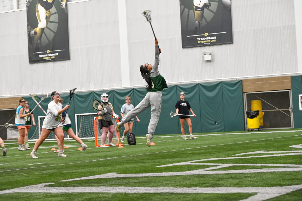 Maura Mequi jumps for the ball during a Colorado State University womens lacrosse club team practice March 6.