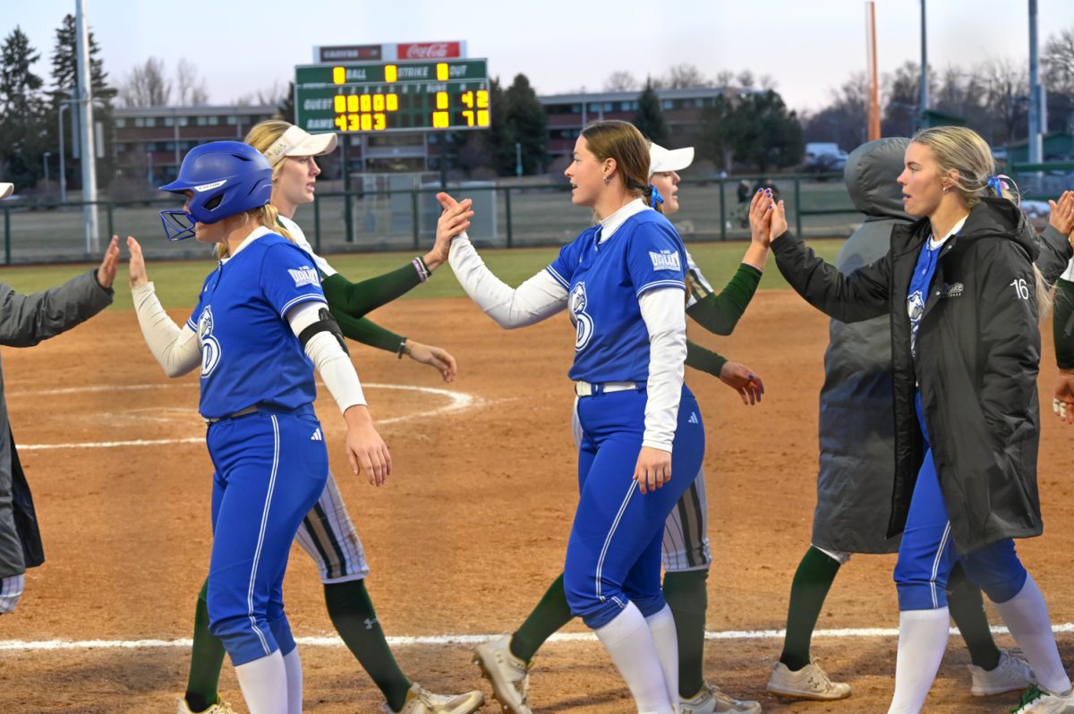 The CSU sfotball team high fives the Drake softball team after their game on March 9, 2024. (CSU won 10-0)