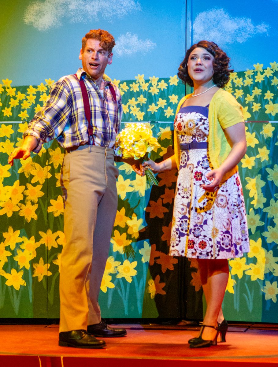 A man and a woman perform on stage.