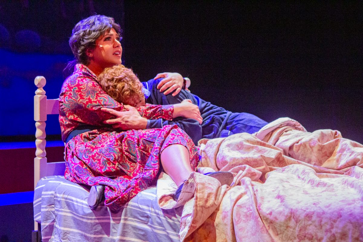 A woman and a man perform on stage.