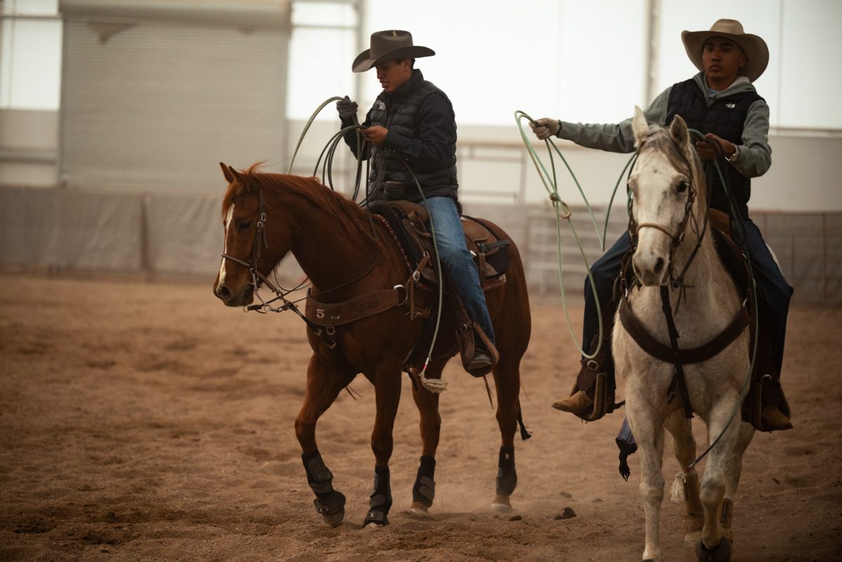 Ral’shaun Descheny and Diego Rolon ride back from practicing roping a calf at a Colorado State University rodeo team practice in Nuun, Colorado.
