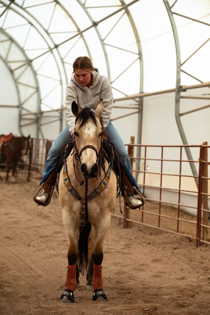 Mckinlee May adjusts her saddle at a Colorado State University rodeo team practice in Nuun, Colorado.