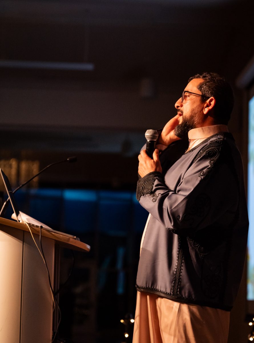 Ahmad Getlawi leads a call to prayer at the Ramadan Iftar Dinner Event.