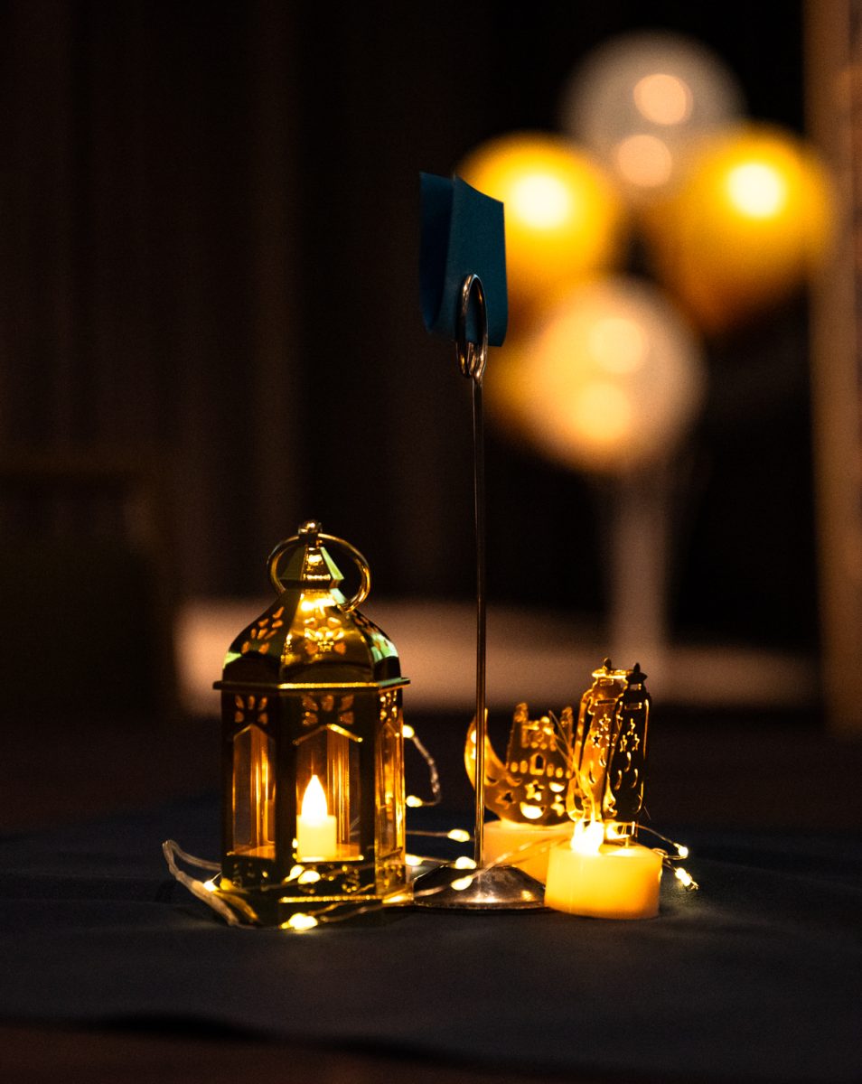 Small lanterns and candles decorate tables at the Ramadan Iftar Dinner Event in the Lory Student Center Ballroom.