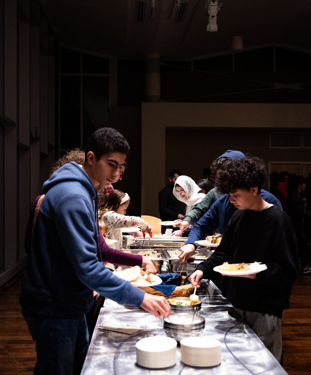 Attendants of the Ramadan Iftar Dinner Event begin getting food in the Lory Student Center Ballroom.