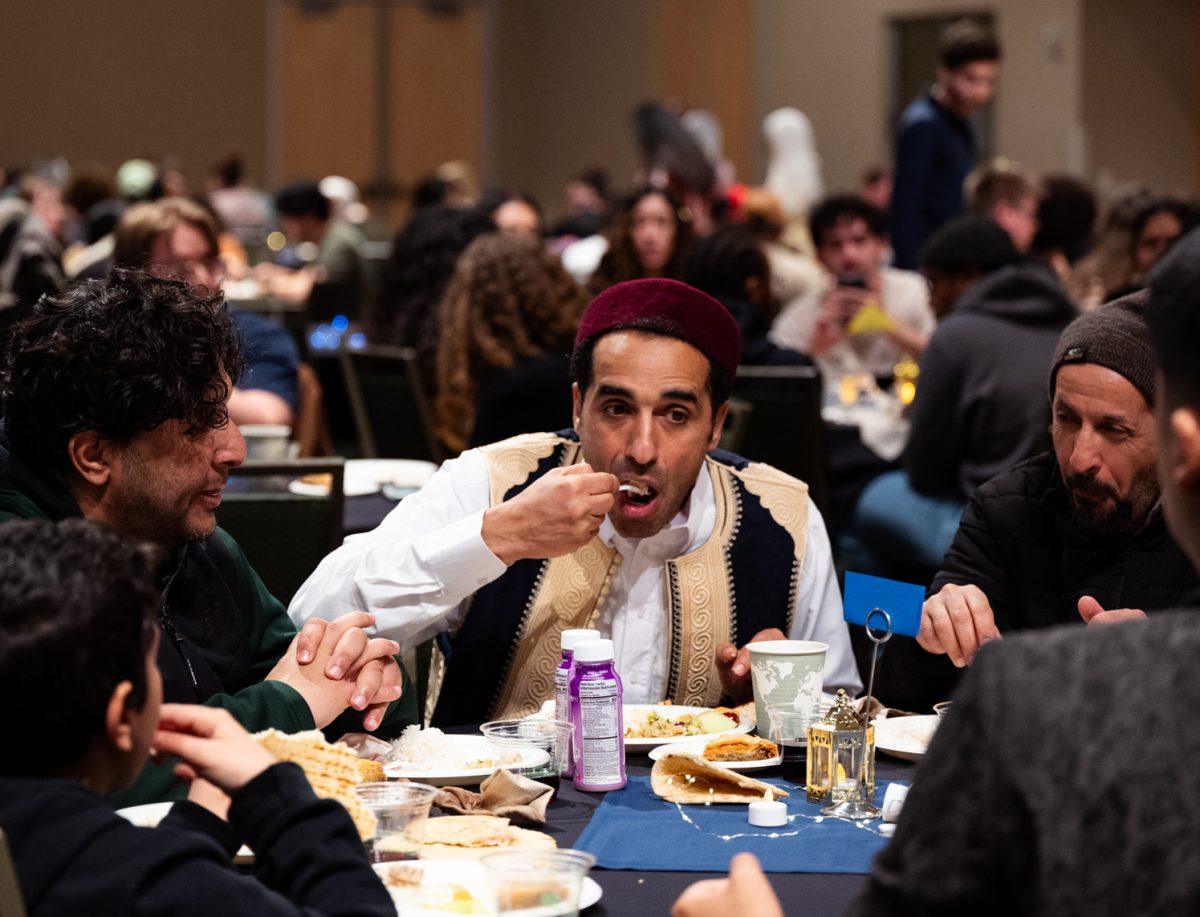 Ramadan Abdunabi, a senior clinical professor at Colorado State University, eats with friends and family at the Ramadan Iftar Dinner Event in the Lory Student Center Ballroom.