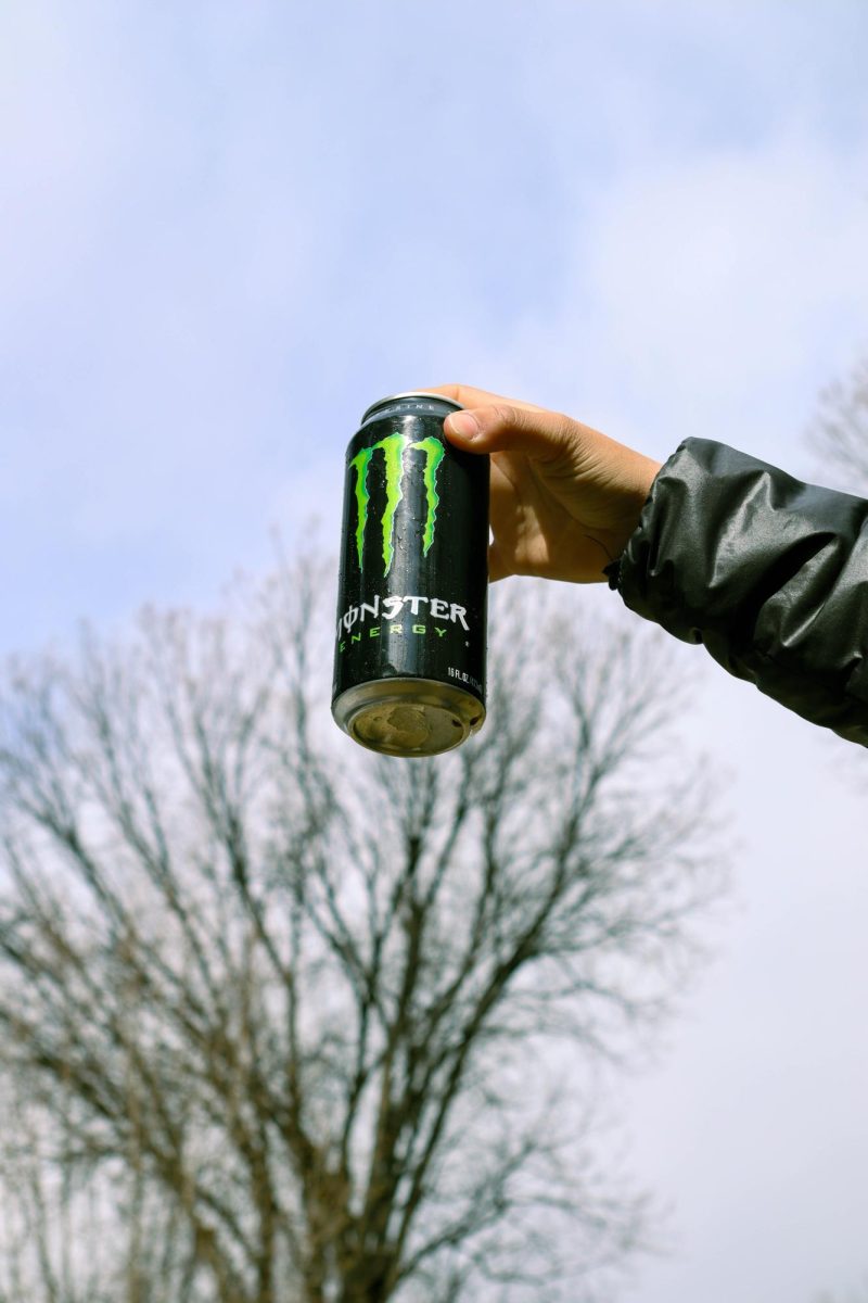 Colorado State University student Sophia Kaczor holds out a Coca-Cola Monster Energy drink. March 26.