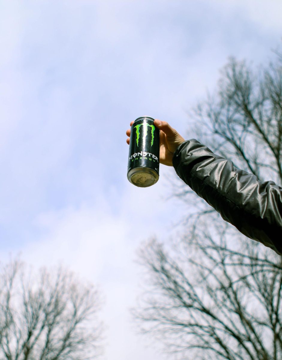 Colorado State University student Sophia Kaczor holds out a Coca-Cola Monster Energy drink. March 26.
