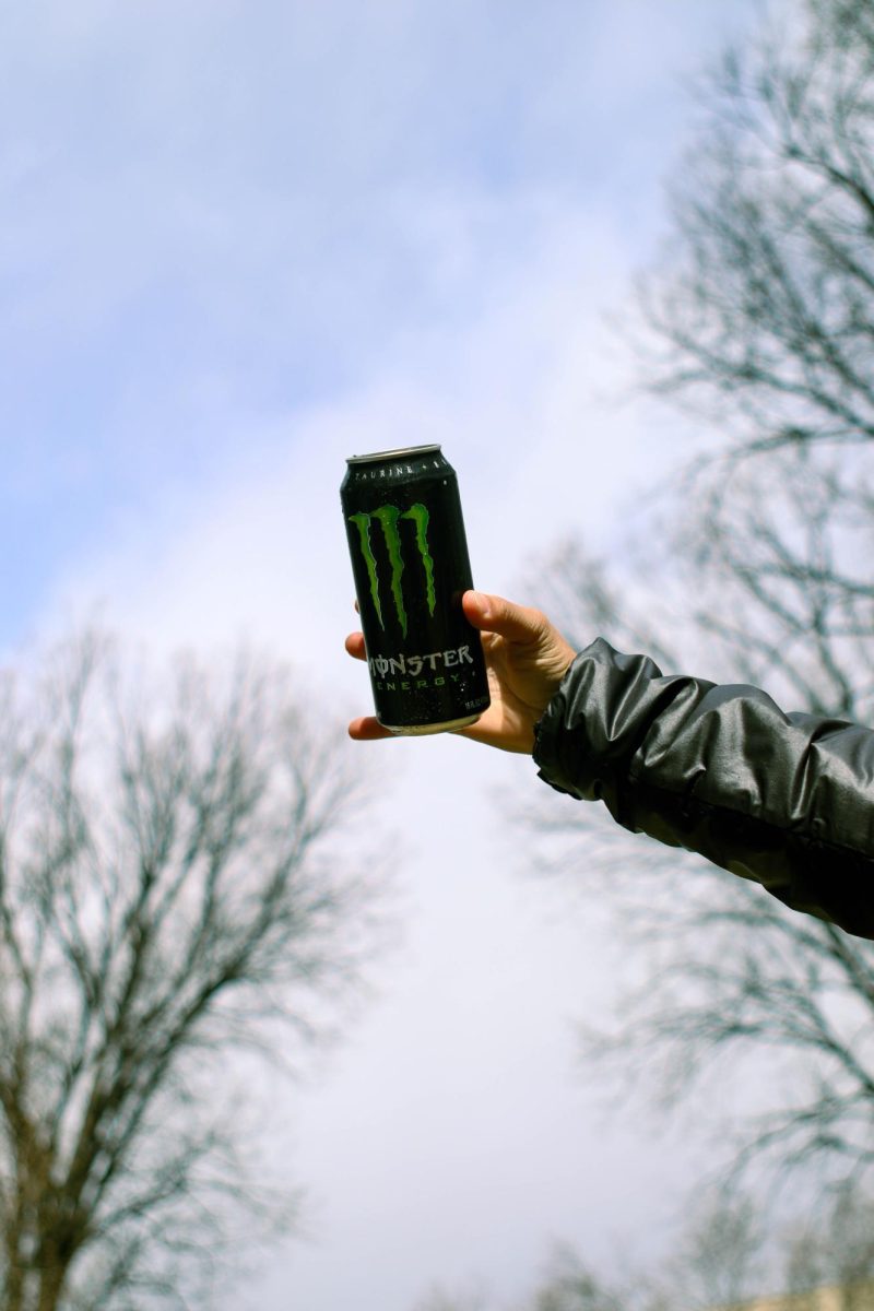 Colorado State University student Sophia Kaczor holds out a Coca-Cola Monster Energy drink. March 26.
