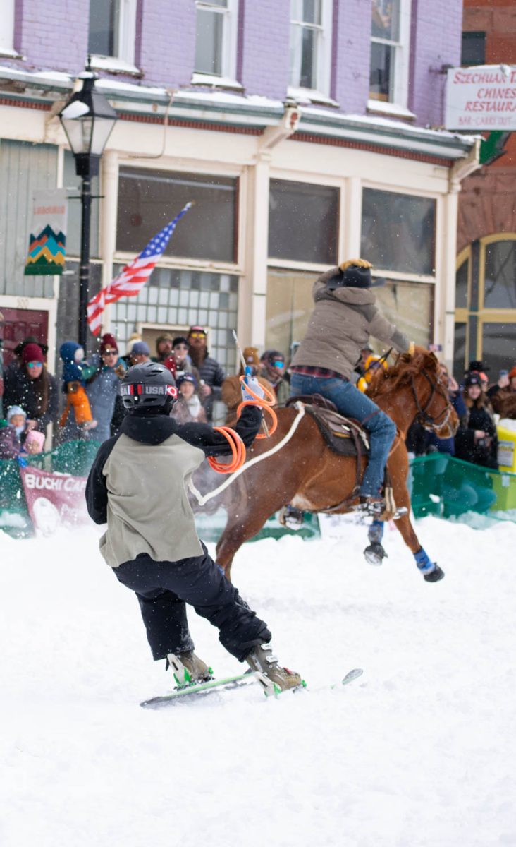 Skijoring skier AJ Pestello snags rings while getting towed by rider Crow Call at the Leadville, Colorado, skijoring event March 3.