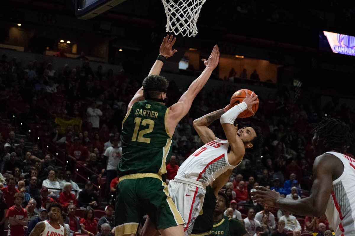 Colorado State University forward Patrick Cartier blocks a shot from University of New Mexico guard Jaelen House in a Mountain West mens basketball championship semifinal March 15. CSU lost to UNM 74-61.