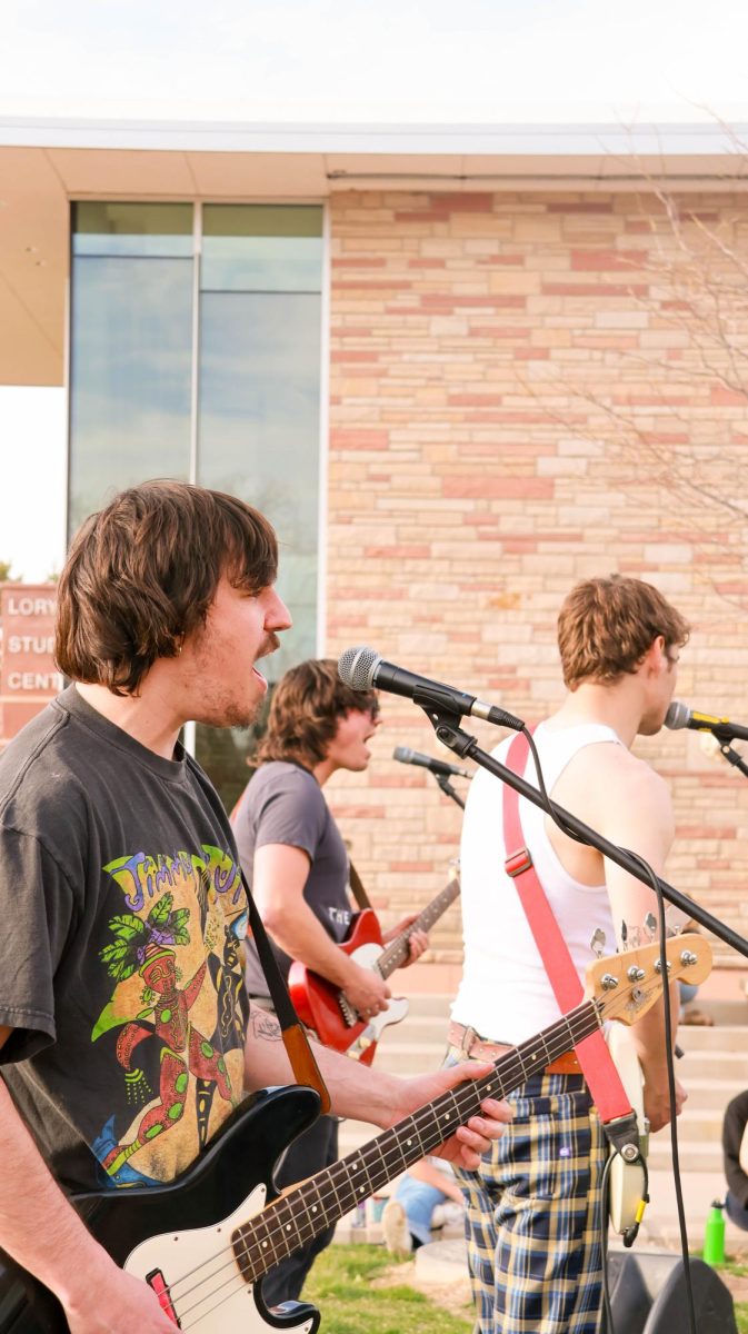 Riley Merino, Colin Kelly and Ian Ehrhart of Jesus Christ Taxi Driver sing harmonies at Fools Fest at Colorado State University April 4.