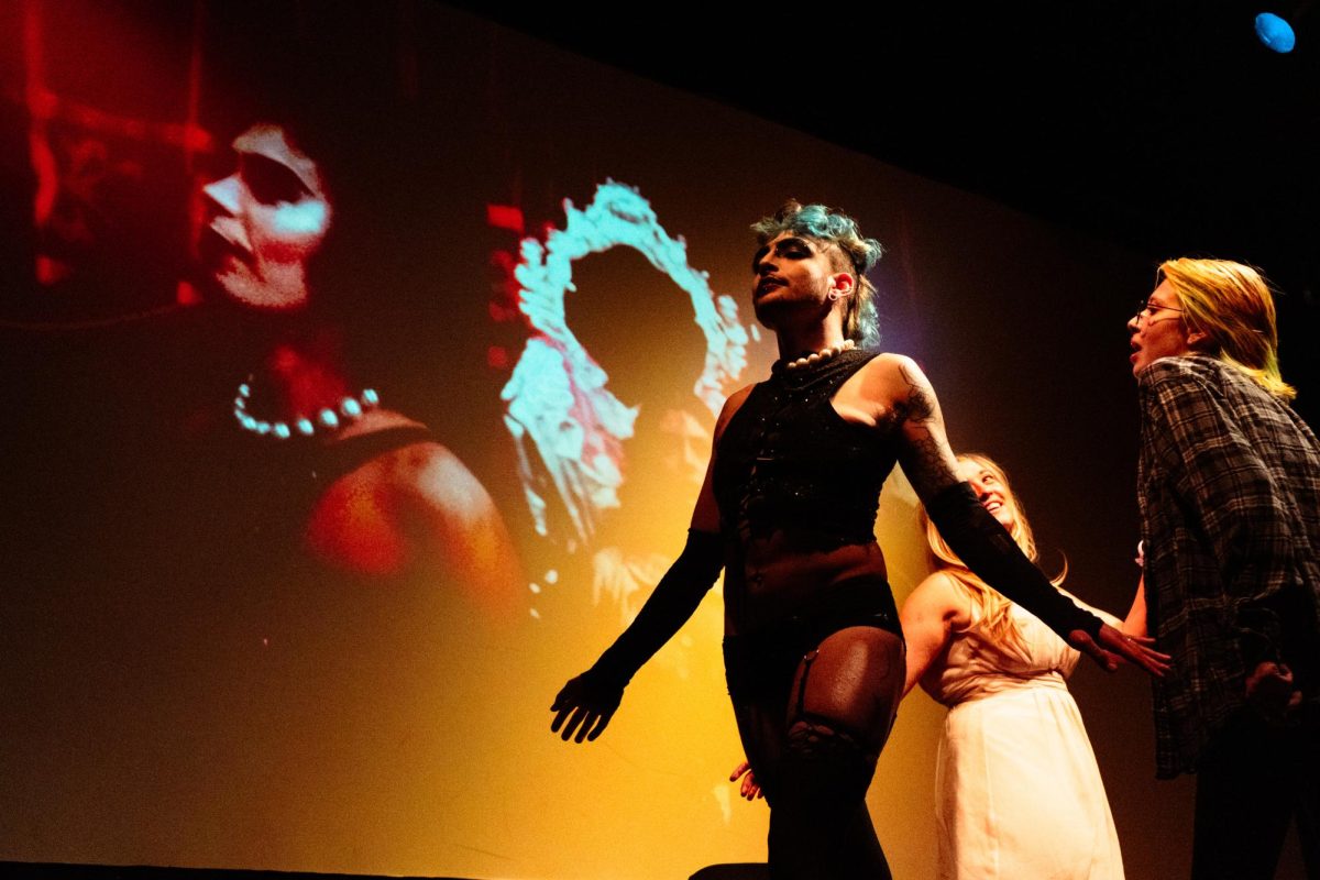 Dr. Frank-N-Furter, played by KevKat, struts across the stage as he welcomes Brad, played by Bekah, and Janet, played by Devour Divinity, to his palace during Sweet Transvestite at No Picnics performance of The Rocky Horror Picture Show at The Lyric April 12.