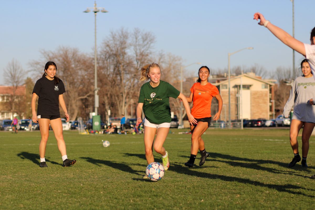 Annabelle Stephan smiles as she plays in a scrimmage during womens club soccer practice April 11.