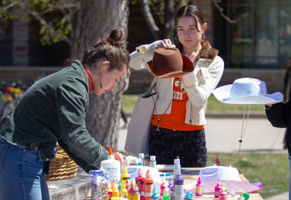 Abbey Amemiya and Julia Morrow take part in painting cowgirl hats April 11 during the Wild Ram Roundup, promoting the upcoming annual RamFest. “I think its awesome that they have all these people out on campus and are working so hard to promote such a sick event,” Amemiya said.